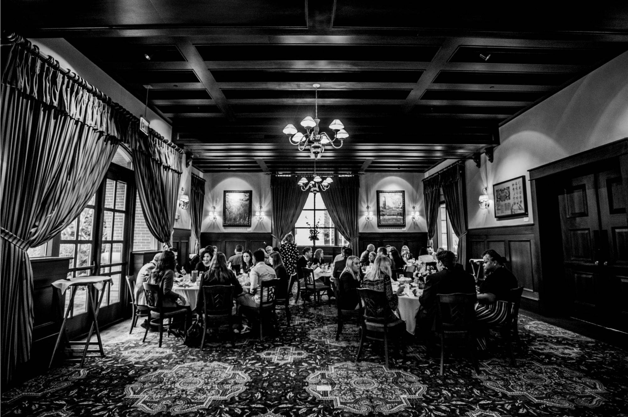 A black and white photo of attendees at tables during a Hauenstein Center Luncheon